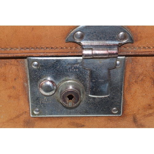 419 - An early 20th century Fortnum and Mason 'Cruzer' leather suitcase with metal fixings and leather han... 