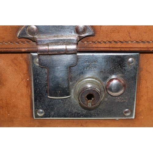 419 - An early 20th century Fortnum and Mason 'Cruzer' leather suitcase with metal fixings and leather han... 