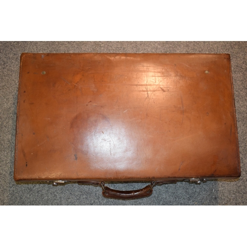 419 - An early 20th century Fortnum and Mason 'Cruzer' leather suitcase with metal fixings and leather han... 