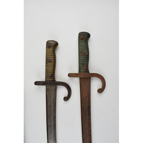 426 - 19th century French Chassepot bayonet in scabbard together with another similar example without scab... 