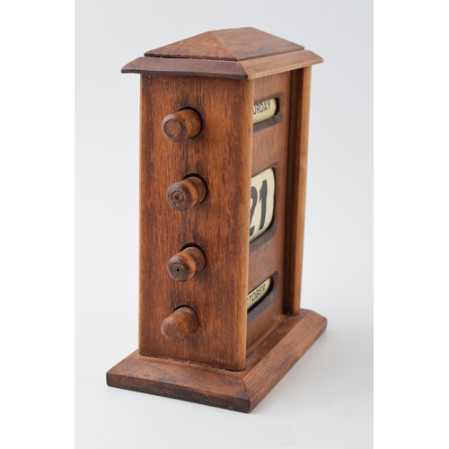 450 - Vintage style perpetual calendar in wooden case with scroll like action, 17cm tall.