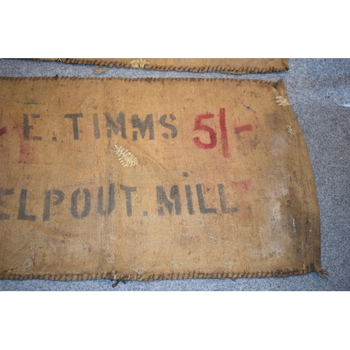 460 - Two vintage corn sacks (red writing) E. TIMMS HELP OUT. MILL 130cm x 70cm (2)