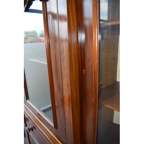 492 - 19th century mahogany breakfront sideboard / glazed bookcase with turned handles and floral carving,... 