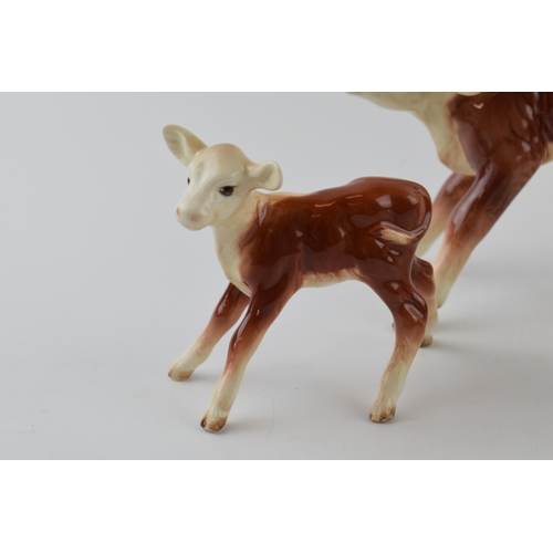 96A - A trio of Beswick calves to include a Guernsey Calf 1249A, a Hereford Calf 854 and a similar 901B (3... 