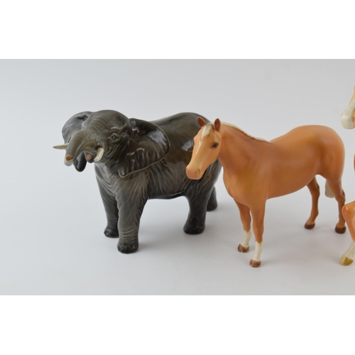 96B - Beswick to include a palomino prancing Arab 1261, an elephant 974 and a matte brown palomino thoroug... 