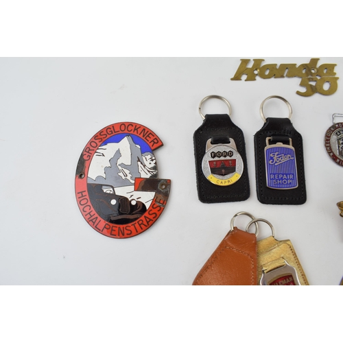 466 - A collection of automobilia badges and similar items to include enamel Grossglockner Hochalpenstrass... 