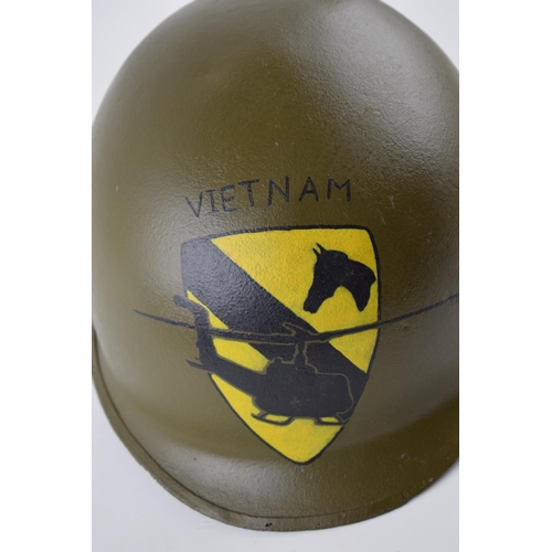 511 - An American military helmet with 'Vietnam' and helicopter crest to front.