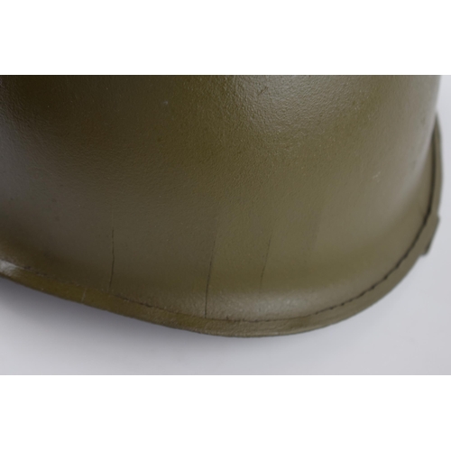 511 - An American military helmet with 'Vietnam' and helicopter crest to front.