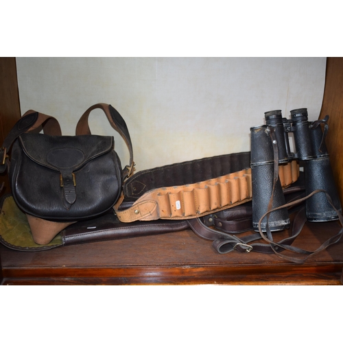 536 - A collection of shooting related items to include leather cartridge belt, leather cartridge bag, pai... 