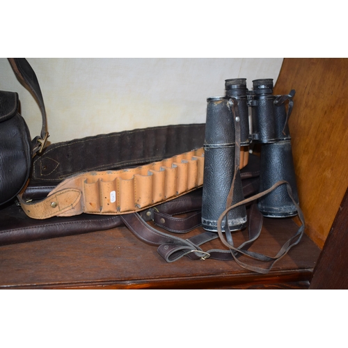 536 - A collection of shooting related items to include leather cartridge belt, leather cartridge bag, pai... 