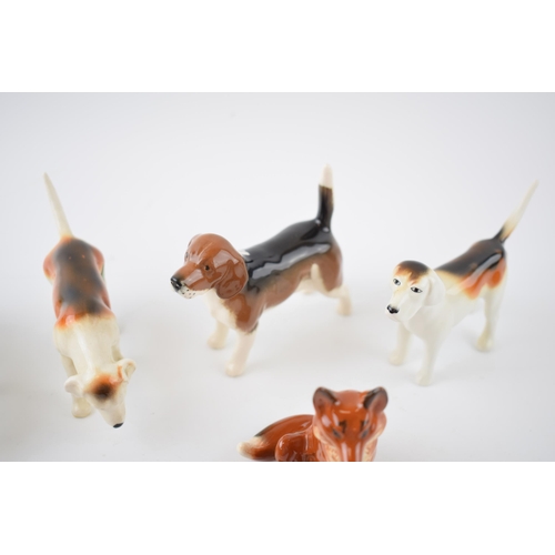 65D - Beswick to include a beagle, 4 various foxhounds and 2 foxes (7).