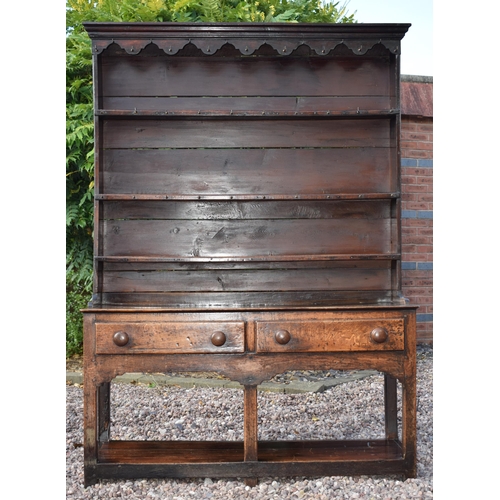 Early 19th century Welsh oak dresser with planked base with 2 drawers with 3 shelf top rack with groove for plates, with turned wooden handles, with good patination with planked back, 132cm wide, 43cm deep and 188cm tall.
