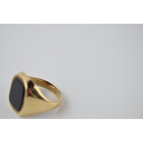 291 - 9ct gold and onyx gents ring with bright cut edge, 7.2 grams, size V.