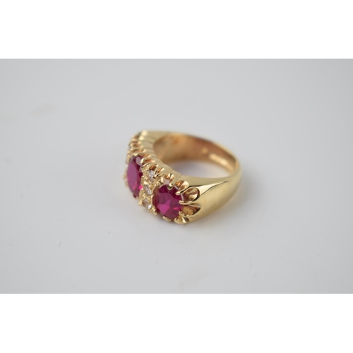 297 - 9ct gold dress ring with 3 bright pink stones with 6 smaller clear stones, 7.2 grams, size K.