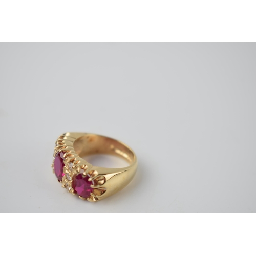 297 - 9ct gold dress ring with 3 bright pink stones with 6 smaller clear stones, 7.2 grams, size K.