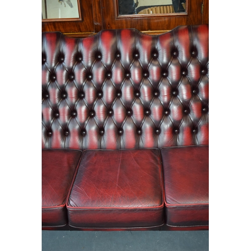 508 - Queen Anne revival chesterfield wingback three seater sofa, with high back, in red leather with butt... 