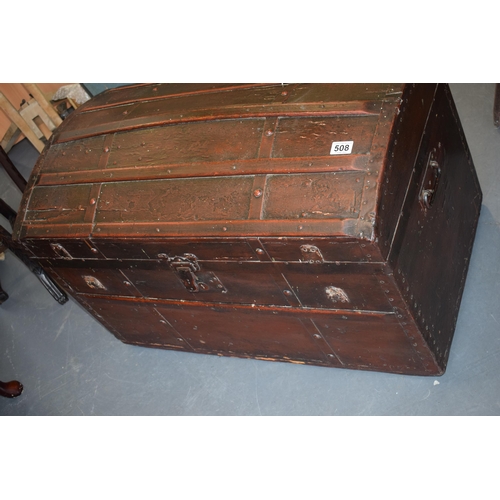 509 - Antique domed top travelling trunk, lined with wall paper, 87cm x 55cm.