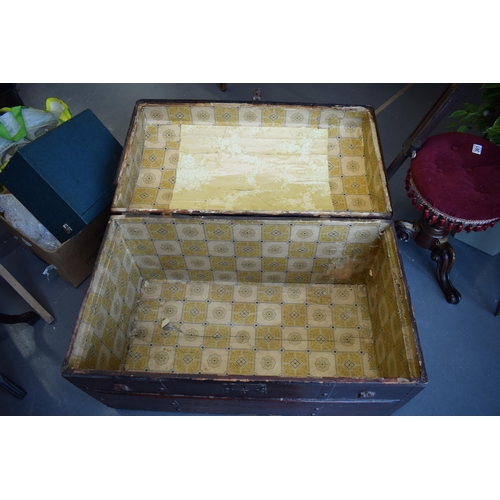 509 - Antique domed top travelling trunk, lined with wall paper, 87cm x 55cm.