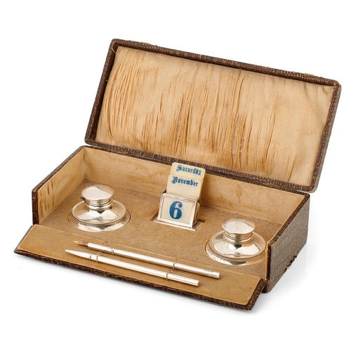 131 - Cased silver writing set to include a perpetual calendar, Birmingham 1925, W Devenport, with linings... 