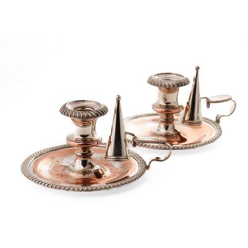 141 - A pair of Victorian Sheffield plate on copper chambersticks (2), 17cm diameter.