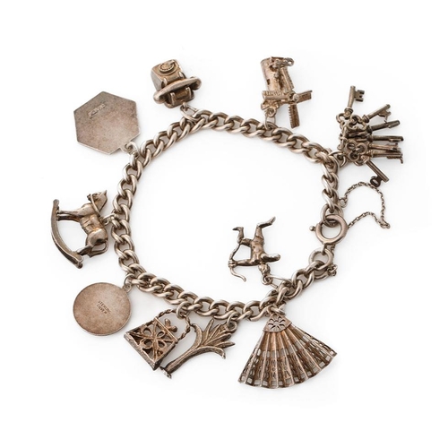 217 - Silver charm bracelet with various charms to include Cupid, a fan, a rocking horse and others, 37.5 ... 