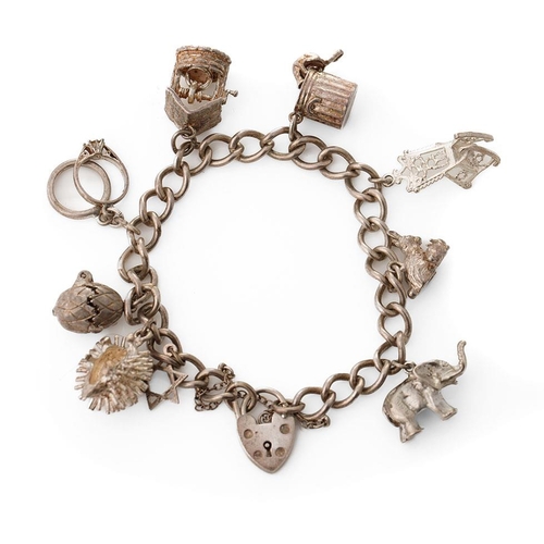 219 - Silver charm bracelet with various charms to include a hedgehog, a pair of rabbits, a well and other... 