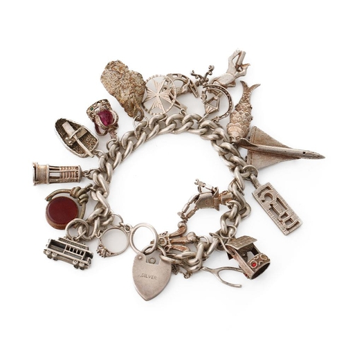 221 - Silver charm bracelet with various charms to include an aeroplane, a tram, a robot, a miner's lamp a... 