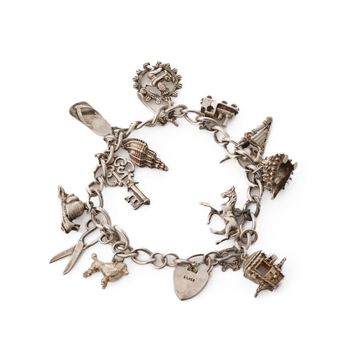 222 - Silver charm bracelet with various charms to include a poodle, a hedgehog, a shell, a carriage and o... 