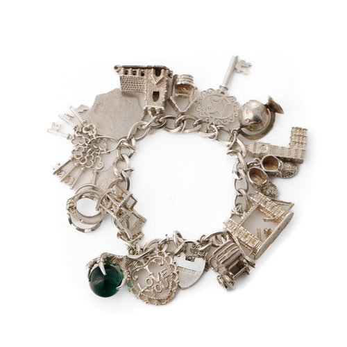 330 - Silver charm bracelet to include Big Ben, London Bridge, keys and others, 68.7 grams.