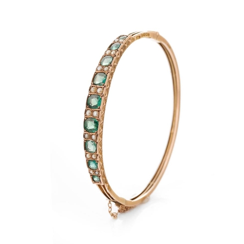 356 - Victorian 9ct gold green tourmaline and pearl bangle, Birmingham 1895, with safety chain, 8.7 grams.