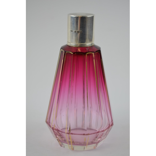 121 - Silver and cranberry glass Art Deco perfume bottle with gilt decoration, London 1937, CD, 12cm tall.