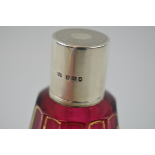 121 - Silver and cranberry glass Art Deco perfume bottle with gilt decoration, London 1937, CD, 12cm tall.