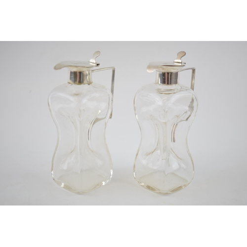 123 - A pair of silver and glass noggins / glug glug jugs, Birmingham 1913, HB & Co, 12cm tall (2).