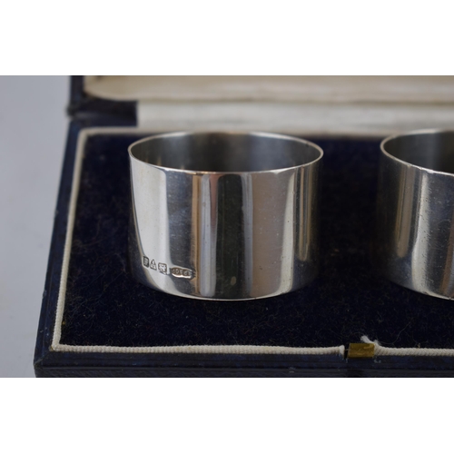 129 - Cased pair of silver napkin rings, Chester 1931, CP & Co, 63.7 grams.