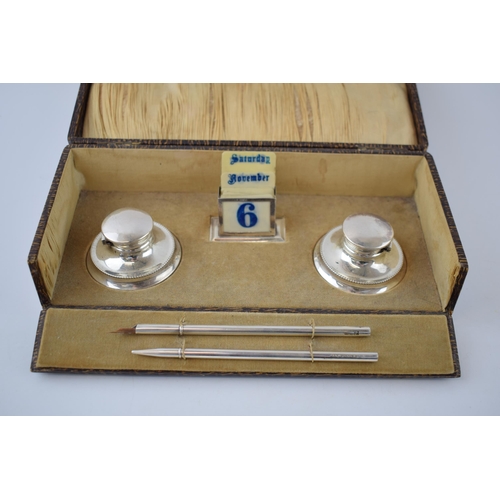 131 - Cased silver writing set to include a perpetual calendar, Birmingham 1925, W Devenport, with linings... 