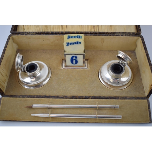 131 - Cased silver writing set to include a perpetual calendar, Birmingham 1925, W Devenport, with linings... 