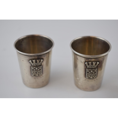 134 - A collection of silver items to include cognac cups of WWI interest with Amiens crest, a William Coo... 