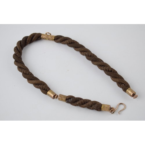 196 - Early Victorian mourning watch chain made with finely plaited hair and gold mounts (test as 9ct or b... 