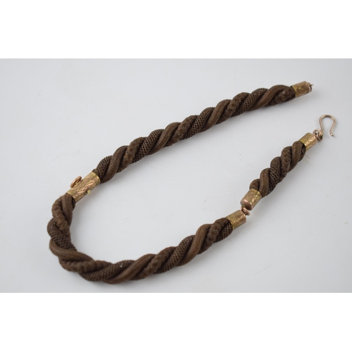 196 - Early Victorian mourning watch chain made with finely plaited hair and gold mounts (test as 9ct or b... 