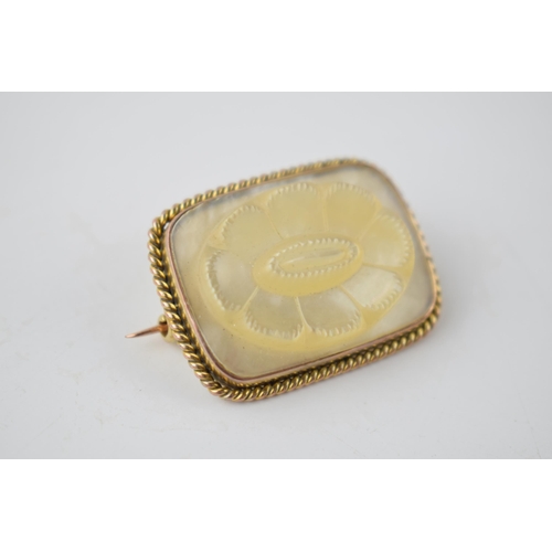 199 - Yellow metal brooch (tests as circa 18ct) with carved Mother of Pearl decoration in the form of a fl... 