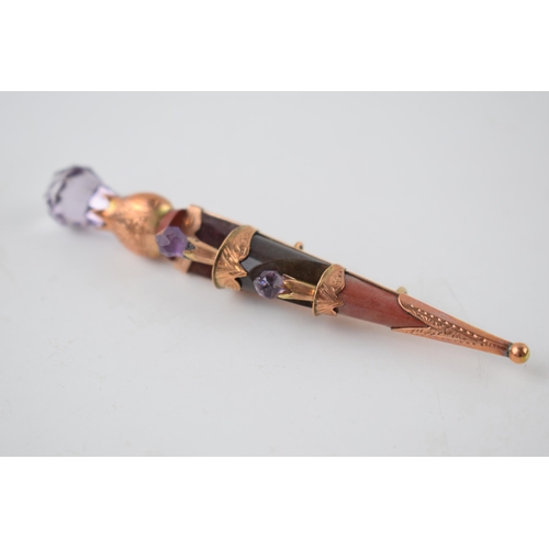 205 - Victorian 9ct gold sword brooch set with agate and amethysts, 85mm wide, 12.2 grams.