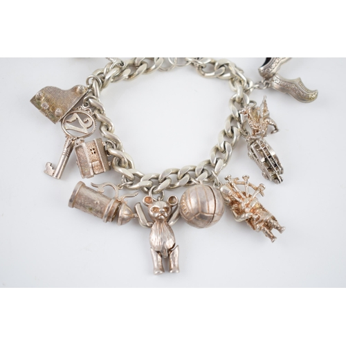 224 - Silver charm bracelet with various charms to include a football, a bell, a tankard, a fire engine an... 