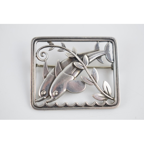 235 - A Georg Jensen silver brooch, designed by Arno Malinowski. 'Leaping Dolphins' in a rectangular frame... 