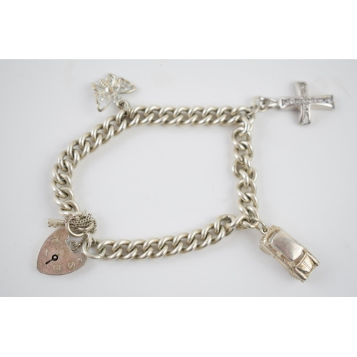 237 - Silver charm bracelet with charms to include a car, a cross and others, 34.7 grams.