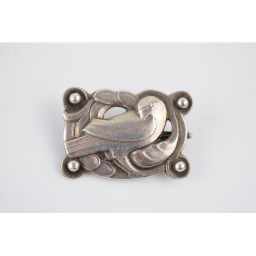 241 - Georg Jensen silver 'Dove' brooch designed in 1904 by Kristian Moehl-Hansen. Framed by stylised natu... 