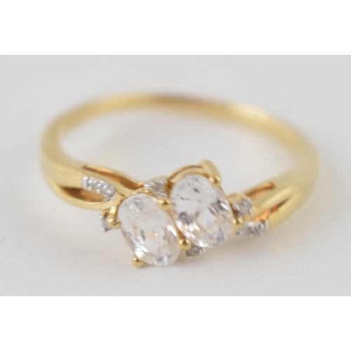 253 - 10ct gold ladies ring set with illusion set diamonds and larger white stones, 2.7 grams, size T.