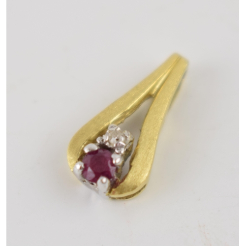 261 - 18ct gold pendant set with a ruby and a diamond, 1.3 grams, 16mm tall.