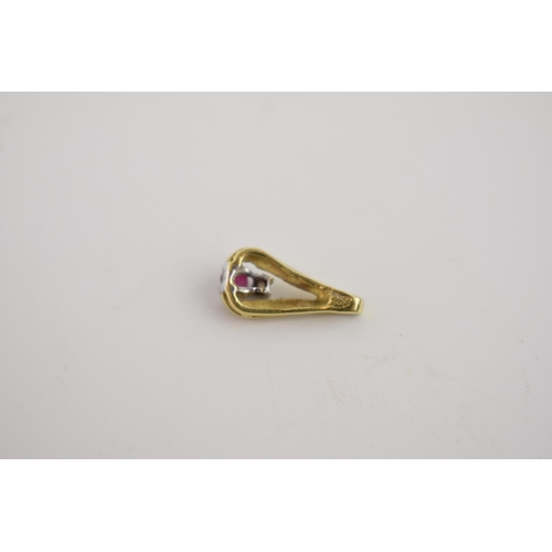 261 - 18ct gold pendant set with a ruby and a diamond, 1.3 grams, 16mm tall.