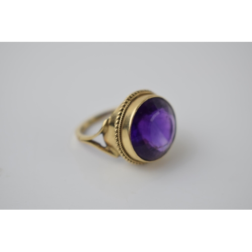 264 - 9ct gold ring set with circular purple stone, 5.2 grams, size M.