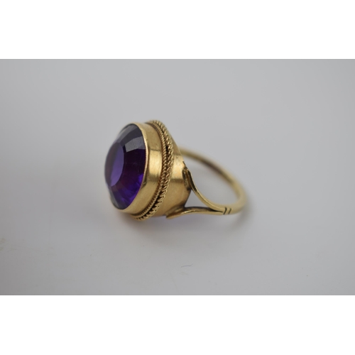 264 - 9ct gold ring set with circular purple stone, 5.2 grams, size M.